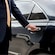 A private driver opening the door of a luxury sedan